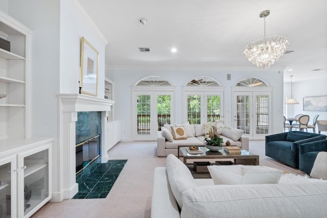 6008 Woodview Ave, Austin, TX 78757 - carpeted living room with crown molding, a chandelier, and a high end fireplace