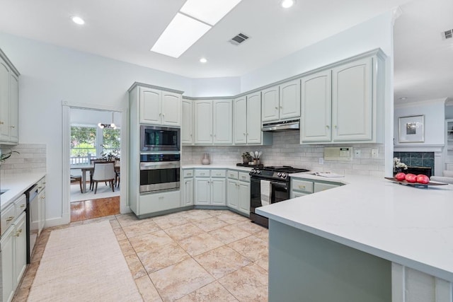 6008 Woodview Ave, Austin, TX 78757 - kitchen with stainless steel appliances, under cabinet range hood, tasteful backsplash, recessed lighting, and light countertops