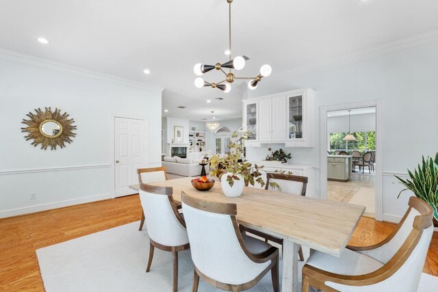 6008 Woodview Ave, Austin, TX 78757 - dining space featuring crown molding, a chandelier, recessed lighting, and light wood finished floors