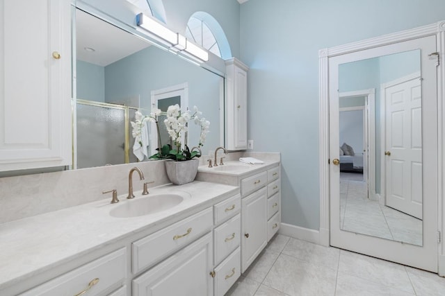 6008 Woodview Ave, Austin, TX 78757 - full bath featuring double vanity, a shower stall, tile patterned floors, and connected bathroom
