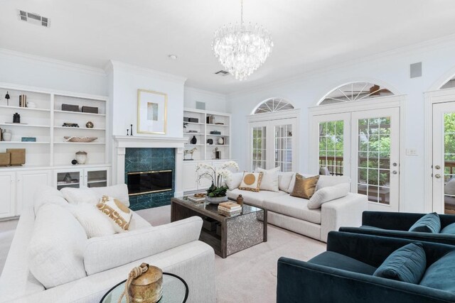 6008 Woodview Ave, Austin, TX 78757 - living area featuring crown molding, a chandelier, light carpet, a premium fireplace, and built in shelves