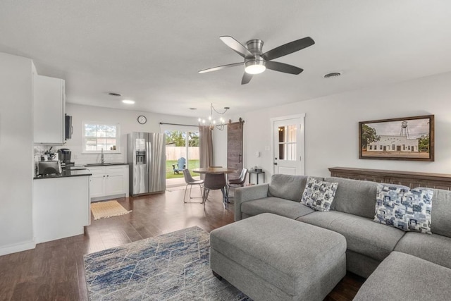 219 S Bluff St, Dripping Springs, TX 78620 - living area featuring ceiling fan, a chandelier, and dark wood-style flooring