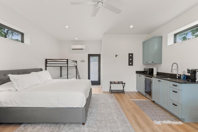 219 S Bluff St, Dripping Springs, TX 78620 - bedroom featuring a sink, multiple windows, light wood-style floors, and recessed lighting