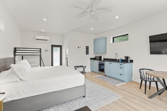 219 S Bluff St, Dripping Springs, TX 78620 - bedroom featuring beverage cooler, light wood-style floors, a wall mounted AC, wet bar, and recessed lighting