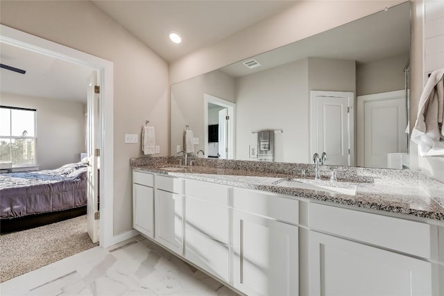 3204 Mount Vernon Ave, Lago Vista, TX 78645 - ensuite bathroom featuring double vanity, marble finish floors, and baseboards