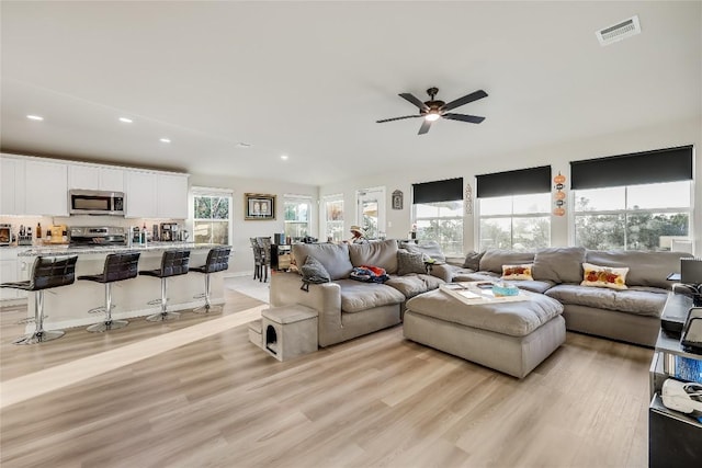 3204 Mount Vernon Ave, Lago Vista, TX 78645 - living room featuring light wood-style floors, ceiling fan, healthy amount of natural light, and recessed lighting