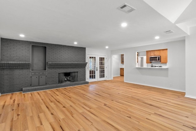801 Lime Rock Dr, Round Rock, TX 78681 - unfurnished living room featuring light wood finished floors, a fireplace, and recessed lighting