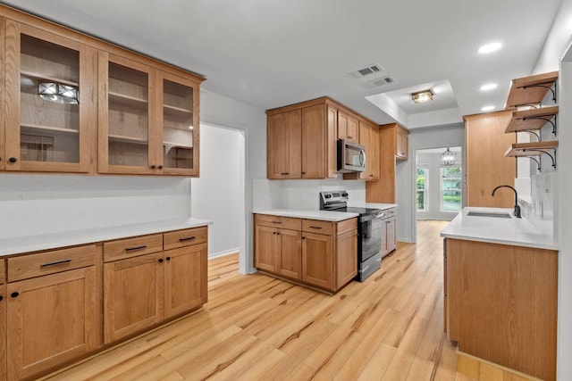 801 Lime Rock Dr, Round Rock, TX 78681 - kitchen featuring appliances with stainless steel finishes, open shelves, light wood finished floors, light countertops, and recessed lighting