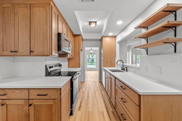 801 Lime Rock Dr, Round Rock, TX 78681 - kitchen featuring stainless steel appliances, open shelves, light wood-style flooring, recessed lighting, and light countertops
