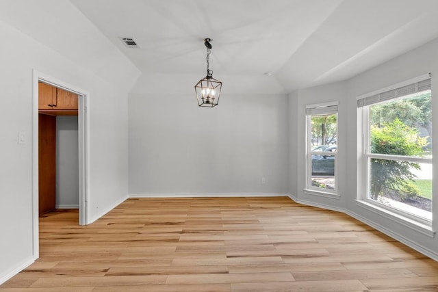 801 Lime Rock Dr, Round Rock, TX 78681 - unfurnished dining area with a chandelier, light wood-style floors, and lofted ceiling