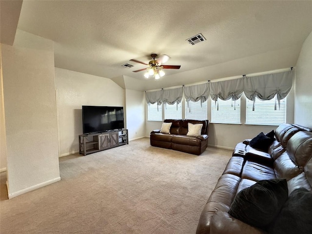 404 Autumn Trl, Georgetown, TX 78626 - carpeted living room featuring ceiling fan, baseboards, and a textured ceiling