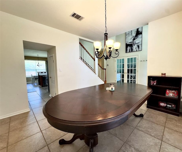 404 Autumn Trl, Georgetown, TX 78626 - dining room with a chandelier, french doors, tile patterned flooring, stairs, and baseboards