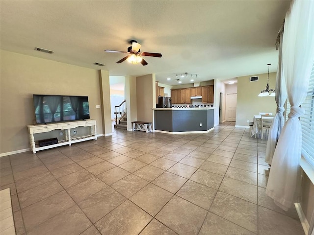 404 Autumn Trl, Georgetown, TX 78626 - living room featuring light tile patterned floors, a ceiling fan, baseboards, and stairs