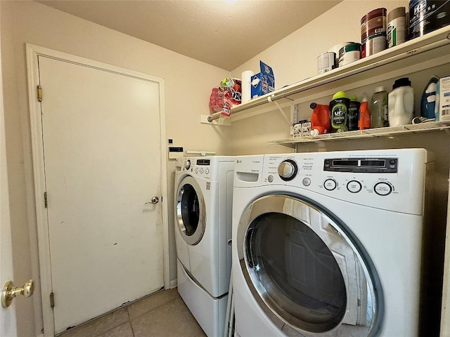 404 Autumn Trl, Georgetown, TX 78626 - laundry area with washer and clothes dryer and light tile patterned flooring