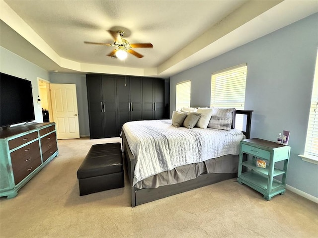 404 Autumn Trl, Georgetown, TX 78626 - bedroom with light carpet, a raised ceiling, and multiple windows