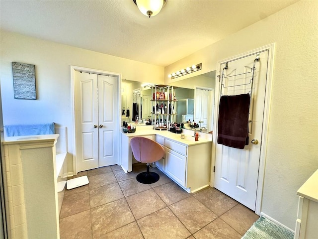 404 Autumn Trl, Georgetown, TX 78626 - full bath with vanity, baseboards, tile patterned floors, and a tub