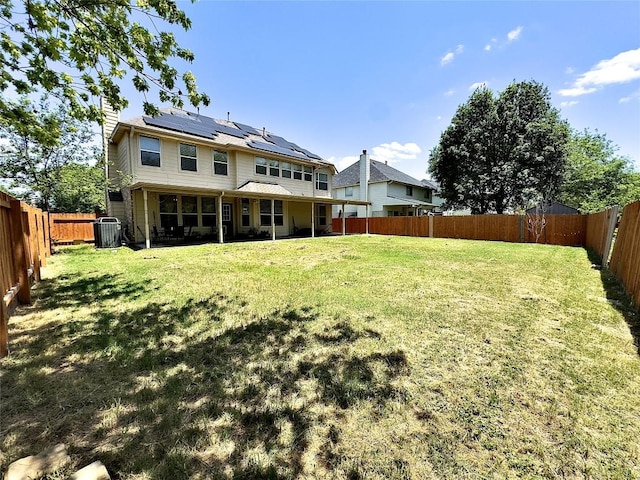 404 Autumn Trl, Georgetown, TX 78626 - back of house with central air condition unit, solar panels, and a chimney