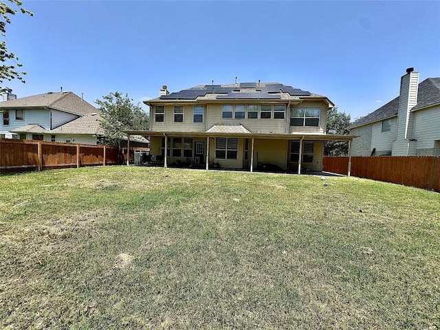 404 Autumn Trl, Georgetown, TX 78626 - rear view of property with roof mounted solar panels, a patio, and a chimney
