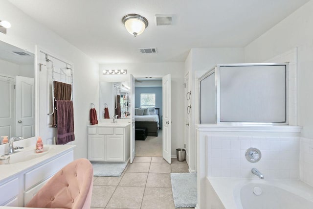 404 Autumn Trl, Georgetown, TX 78626 - ensuite bathroom with vanity, a garden tub, tile patterned floors, and a stall shower