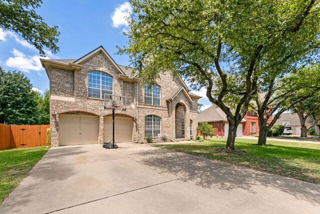 404 Autumn Trl, Georgetown, TX 78626 - view of front of property featuring brick siding, driveway, and a garage