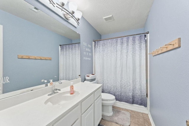 404 Autumn Trl, Georgetown, TX 78626 - full bathroom featuring vanity, a textured ceiling, shower / bath combo with shower curtain, and tile patterned floors