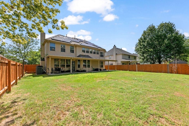 404 Autumn Trl, Georgetown, TX 78626 - back of house featuring solar panels, a chimney, a fenced backyard, and a patio
