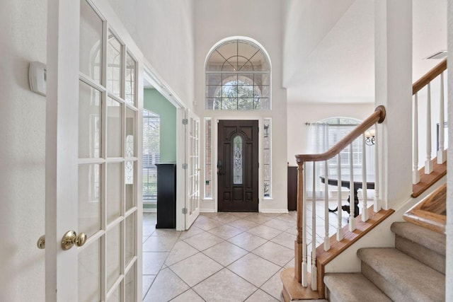 404 Autumn Trl, Georgetown, TX 78626 - entryway featuring a towering ceiling, stairs, and light tile patterned floors