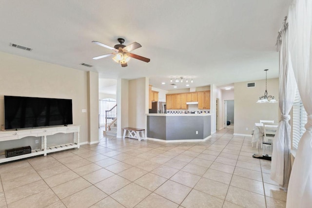 404 Autumn Trl, Georgetown, TX 78626 - living area featuring light tile patterned floors, ceiling fan, and stairs