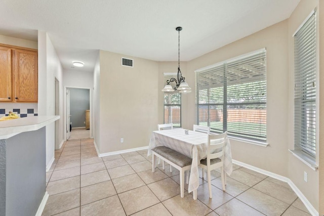 404 Autumn Trl, Georgetown, TX 78626 - dining room featuring light tile patterned flooring and a chandelier
