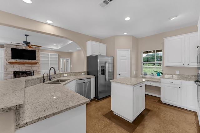 518 Clear Creek Ln, Dripping Springs, TX 78620 - kitchen with appliances with stainless steel finishes, a sink, ceiling fan, a kitchen island, and concrete floors