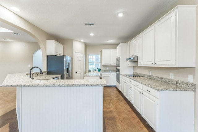 518 Clear Creek Ln, Dripping Springs, TX 78620 - kitchen with stainless steel appliances, a peninsula, white cabinetry, concrete floors, and recessed lighting