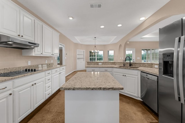 518 Clear Creek Ln, Dripping Springs, TX 78620 - kitchen featuring stainless steel appliances, a raised ceiling, white cabinetry, arched walkways, and recessed lighting