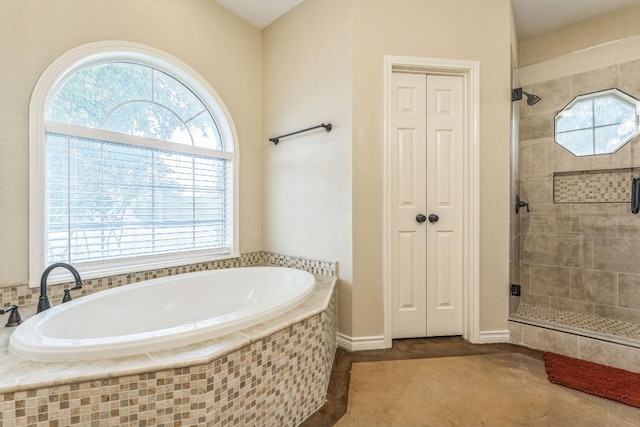 518 Clear Creek Ln, Dripping Springs, TX 78620 - bathroom featuring a bath, a stall shower, healthy amount of natural light, and a closet