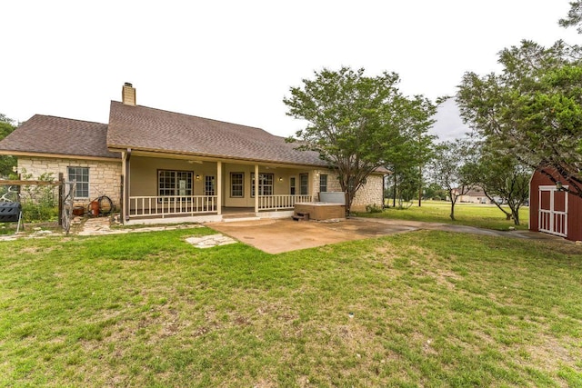 518 Clear Creek Ln, Dripping Springs, TX 78620 - back of house featuring a chimney, stone siding, a yard, a patio, and a shingled roof