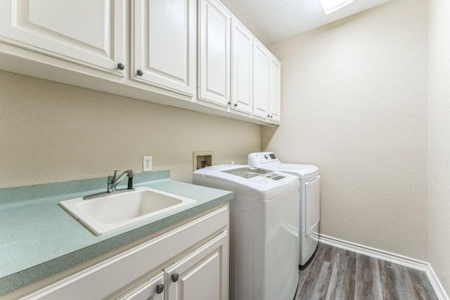 518 Clear Creek Ln, Dripping Springs, TX 78620 - washroom with washer and clothes dryer, baseboards, cabinet space, and wood finished floors