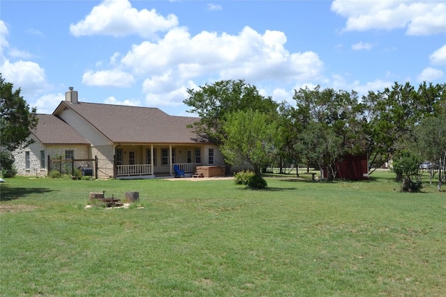 518 Clear Creek Ln, Dripping Springs, TX 78620 - rear view of property featuring a yard, a chimney, a shingled roof, and covered porch