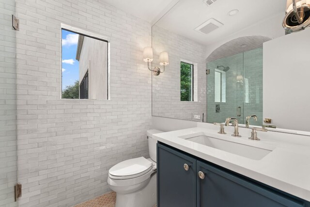 4622 Lake View Dr, Austin, TX 78731 - bathroom featuring toilet, vanity, tile walls, and a stall shower