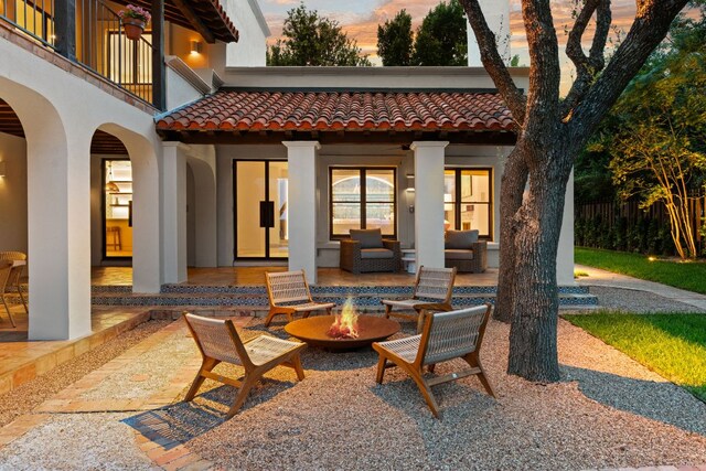 4622 Lake View Dr, Austin, TX 78731 - patio terrace at dusk featuring a patio area, a balcony, and an outdoor living space with a fire pit