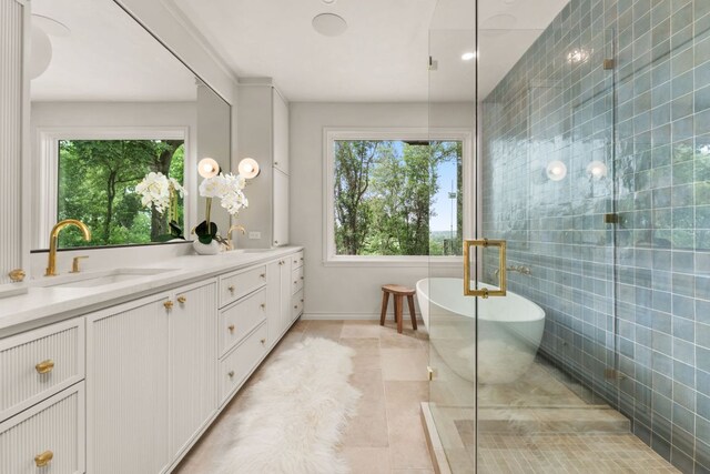 4622 Lake View Dr, Austin, TX 78731 - full bathroom with a soaking tub, double vanity, tile walls, a shower with shower door, and baseboards