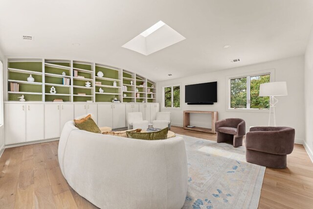 4622 Lake View Dr, Austin, TX 78731 - living room with a skylight, light wood-style flooring, and vaulted ceiling