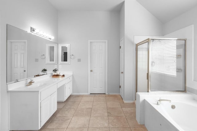 10701 Redmond Rd, Austin, TX 78739 - full bathroom featuring vanity, a garden tub, a shower stall, tile patterned flooring, and high vaulted ceiling