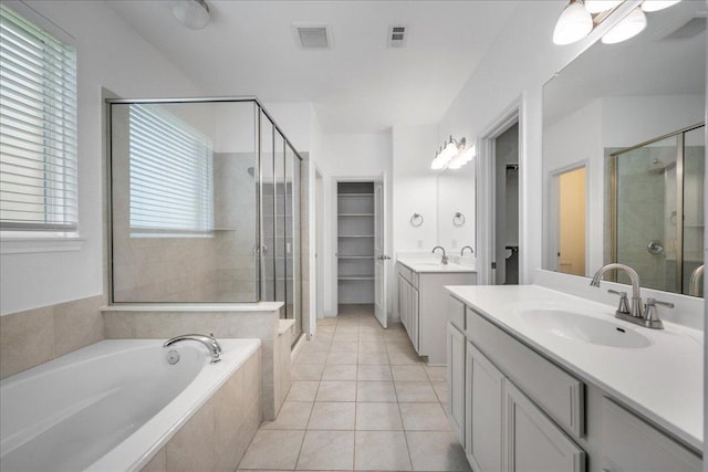 1013 S San Marcos St, Manor, TX 78653 - full bath featuring a shower stall, two vanities, a garden tub, and healthy amount of natural light