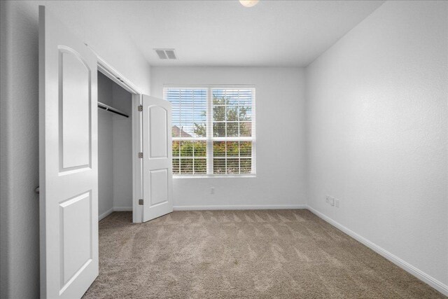 1013 S San Marcos St, Manor, TX 78653 - unfurnished bedroom with carpet flooring and a closet