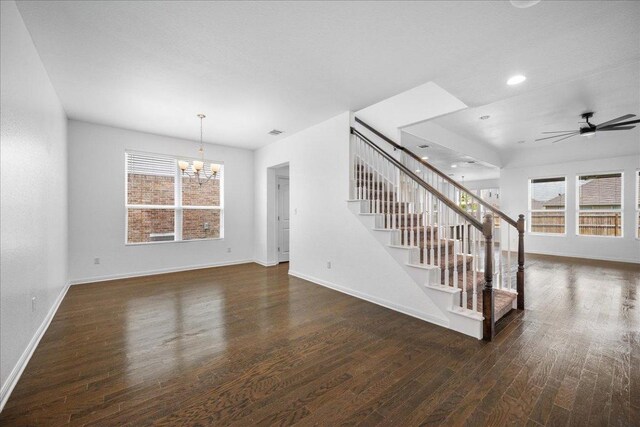 1013 S San Marcos St, Manor, TX 78653 - unfurnished living room with wood finished floors, stairway, healthy amount of natural light, a chandelier, and recessed lighting