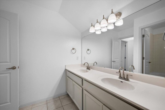1013 S San Marcos St, Manor, TX 78653 - full bathroom featuring double vanity, lofted ceiling, and tile patterned flooring