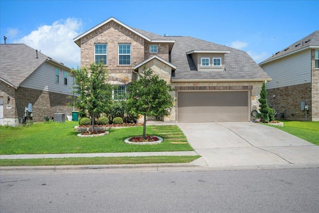 1013 S San Marcos St, Manor, TX 78653 - view of front of property with concrete driveway, a garage, stone siding, and a front yard