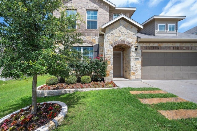 1013 S San Marcos St, Manor, TX 78653 - view of front of property with stone siding, driveway, a front lawn, and a garage