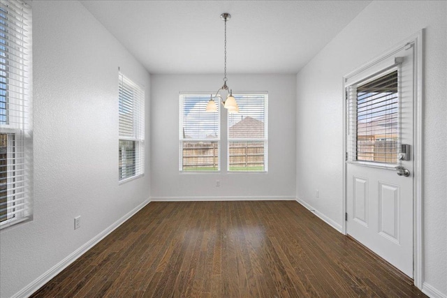 1013 S San Marcos St, Manor, TX 78653 - unfurnished dining area with dark wood-style floors and healthy amount of natural light