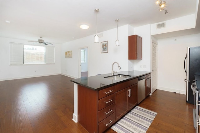3016 Guadalupe St Unit 202, Austin, TX 78705 - kitchen featuring a sink, stainless steel appliances, dark countertops, a ceiling fan, and a peninsula