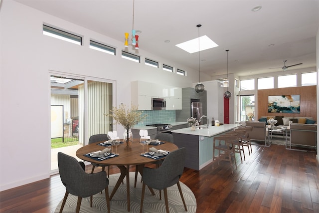 420 Starlight Village Loop Unit 17, Leander, TX 78641 - dining room with dark wood-style flooring, a skylight, ceiling fan, and a high ceiling